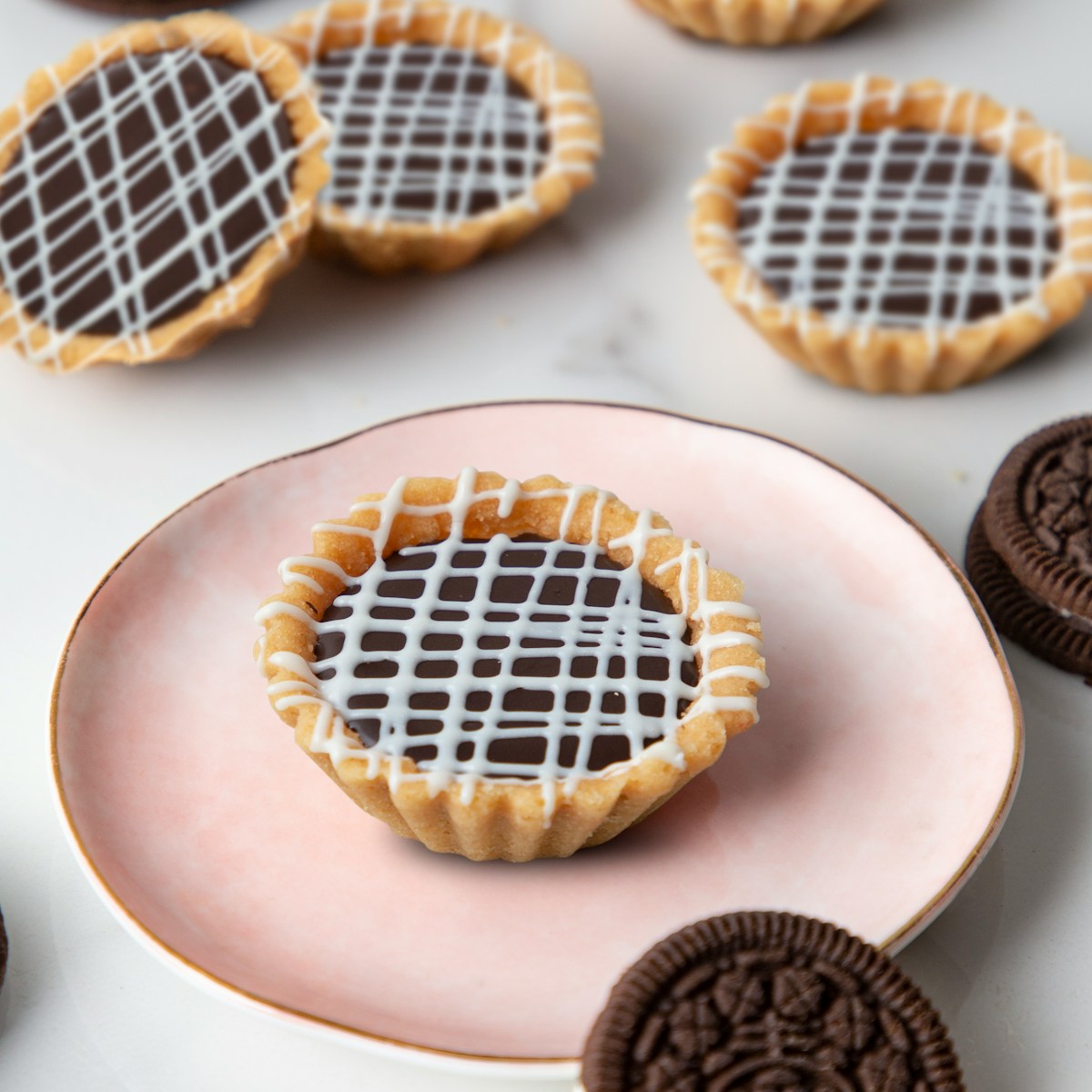 a plate topped with cookies and oreos on top of a table